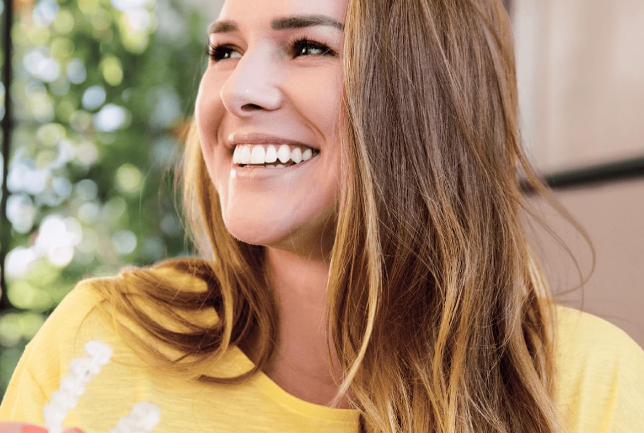 A real patient smiling after orthodontic treatment with Dr Dev Orthodontics