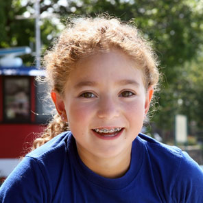A smiling child with straight teeth